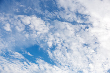 Summer blue sky with white clouds, background, copy space.