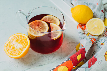Red lemonade with citruses on a light background. Still life.