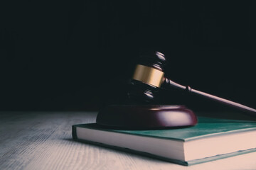Wooden judge gavel and law books.