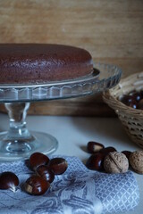 castagnaccio typical Italian cake. Italian food. chestnut pie on glass plate with wooden background