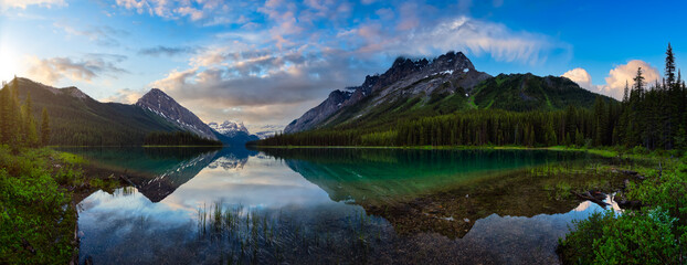 Panoramic View of Beautiful Marvel Lake surrounded by Canadian Rocky Mountains. Colorful Cloudy Sunrise. Located near Banff, boarder of British Columbia and Alberta, Canada. Nature Background Panorama - obrazy, fototapety, plakaty
