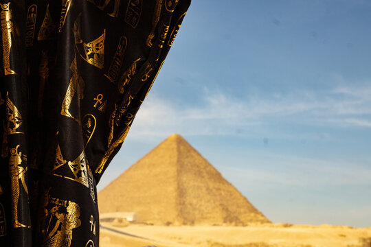 Cloth with hieroglyphs and a great pyramid in background