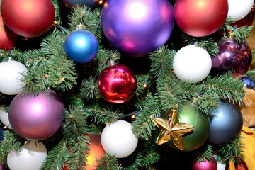 Multicolored Christmas tree toys in the form of balls on the New Year and Christmas tree