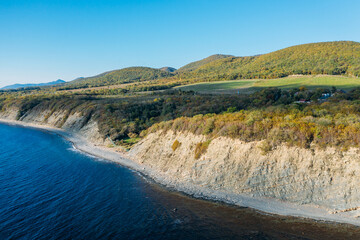 Aerial panoramic view of blue sea coast and rock cliffs. Black sea, wild nature.