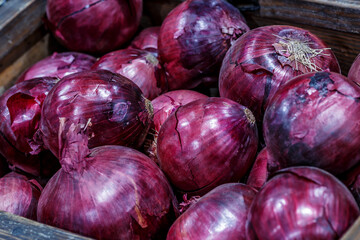 Red onions in plenty on display at local farmer's market, Big fresh red onions background.red onions on rustic wood