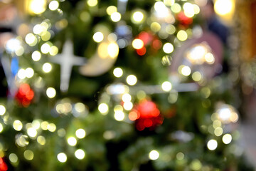 Obraz na płótnie Canvas Blurry New Year and Christmas lights and Christmas toys. New Year and Christmas festive bokeh. Abstract background of garlands and Christmas toys