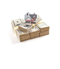 Small House on Stacks of Hundred Dollar Bills Isolated on a White Background