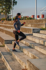 Latin Hispanic woman with black hair doing yoga exercise outdoors in a park