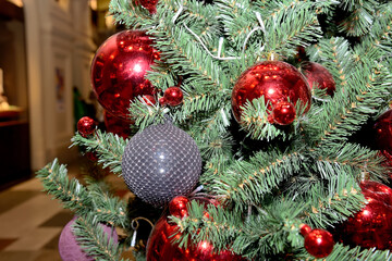 Red and grey Christmas balls on Christmas tree. Close up