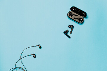 Wired and wireless bluetooth headphones on a blue background