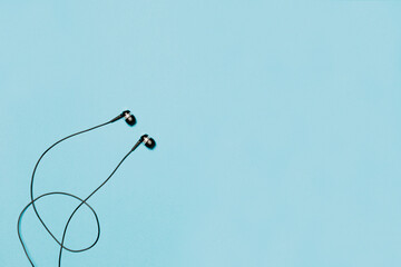 Wired headphones on a blue background