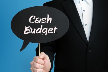 Cash Budget. Businessman holds speech bubble in his hand. Handwritten Word/Text on sign.