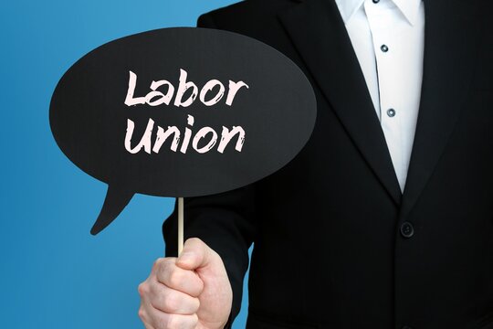 Labor Union. Businessman Holds Speech Bubble In His Hand. Handwritten Word/Text On Sign.