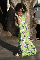 Closeup portrait of Young black girl with afro hairstyle smilling at camera.