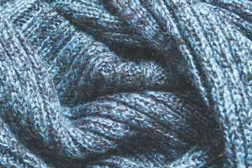 Texture of blue woolen knitted scarf top view