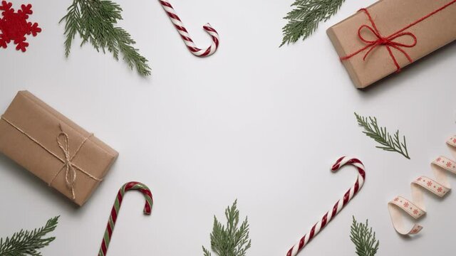 Female hands take a Christmas gift from the decorated table and then put it back. New Year holidays concept with copy space.
