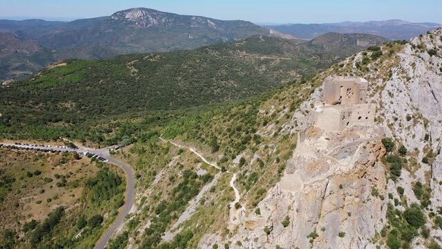 Drone view of ruins of high and isolated medieval defensive Castle de Queribus on stone peak in summer. National heritage site of France