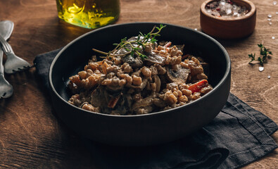 Homemade creamy vegan risotto or orzotto with barley, mushrooms and coconut milk