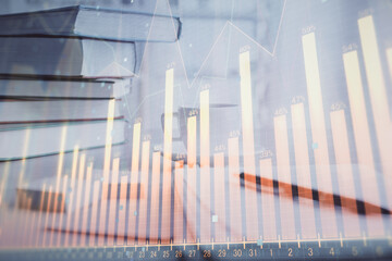 Double exposure of financial chart drawing and desktop with coffee and items on table background. Concept of forex market trading