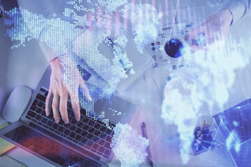 Multi exposure of man's hands typing over computer keyboard and forex graph hologram drawing. Top view. Financial markets concept.