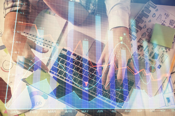 Double exposure of man and woman working together and forex graph hologram drawing. Financial...