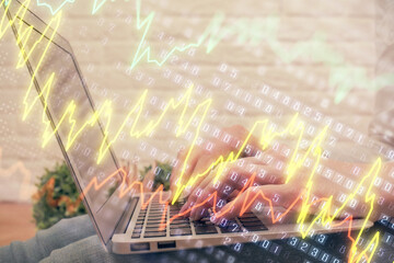 Multi exposure of woman hands typing on computer and forex chart hologram drawing. Stock market analysis concept.