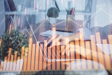 Double exposure of woman hands typing on computer and forex chart hologram drawing. Stock market...