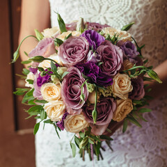 young beautiful bride in white dress holding wedding bouquet, bouquet of bride from rose cream spray, rose bush, rose purple Memory Lane, violet eustoma, eucalyptus .