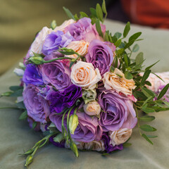 wedding bouquet on a green cushion, bouquet of bride from rose cream spray, rose bush, rose purple Memory Lane, violet eustoma, eucalyptus