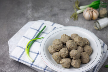 Bakso Sapi or Meatball traditional popular street food in Indonesia, served with clear soup, and...