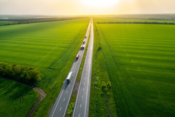 serval trucks whith container   Aerial view landscape. drone photography.  cargo delivery Left side traffic. cargo delivery and transportation concept