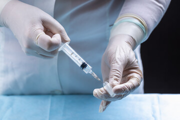 female doctor holding syringe and prepare for making vaccine or drug injection. medicare and...