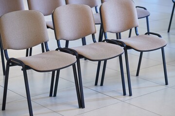 Chairs in rows in an empty autditorium, nobody around