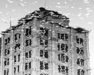 water reflected image of industrial building