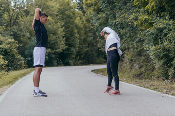 Fototapeta premium Male and female athletes preparing for a marathon, run, workout. Healthy lifestyle concept.