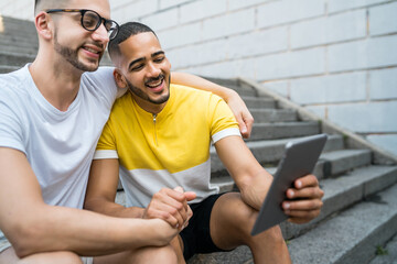 Gay couple using a digital tablet.