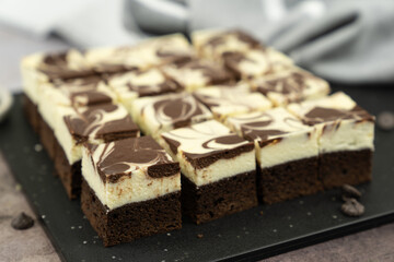 Cutting of homemade cheesecake swirl brownie or fudge
