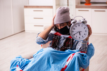 Young man suffering at home from coronavirus in time management