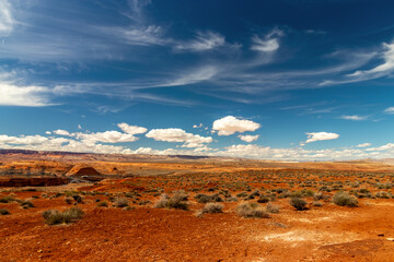 Dark red soil and desert sand with beautiful skies and clouds near Page, AZ