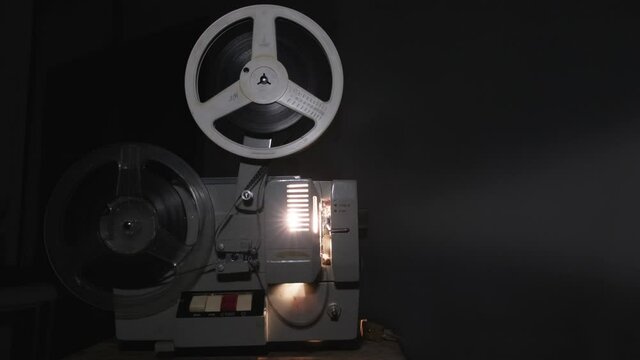 Old 8 mm projector showing film, 4k