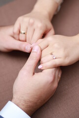 rings on hands of bride