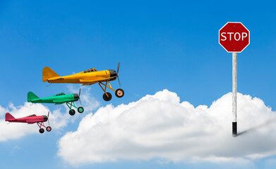 The stop sign is embroidered on clouds and models of vintage military propeller plane model with a...
