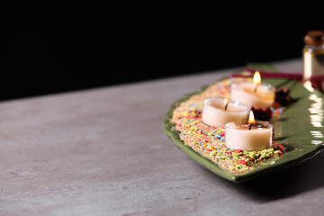 Tray with burning candles for celebration of Divaly on table