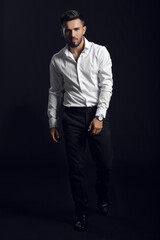 Fototapeta premium Fashionable young man on dark background