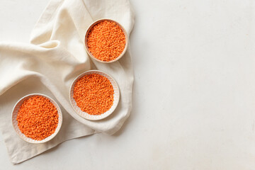 Bowls with raw lentils on light table