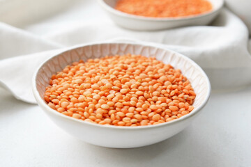 Bowl with raw lentils on light table