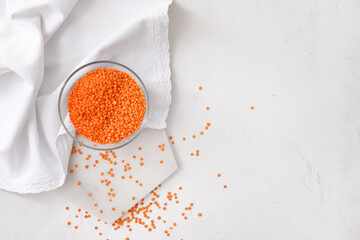 Bowl with raw lentils on light table