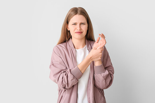 Woman with problem of limbs numbness on light background. Diabetes symptoms