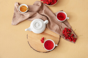 Healthy viburnum tea on color background