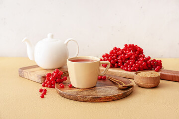 Obraz na płótnie Canvas Cup of healthy viburnum tea on table